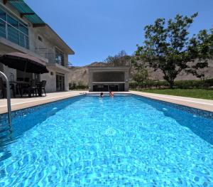 ein Swimmingpool vor einem Haus in der Unterkunft Casa campo las Pecanas Huaral 