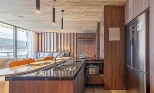 a kitchen with a sink and a refrigerator at New Time Apto 1303 in Maceió