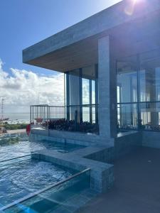 a building with a swimming pool on top of it at New Time Apto 1303 in Maceió