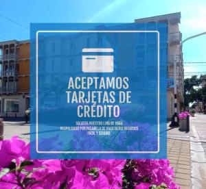 a sign in front of a building with pink flowers at Flowers House Aptos - Centro Histórico in Valledupar