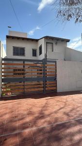 a gate in front of a house at Increible Departamento en Ciudad de Mendoza, a metros de Parque Central y proximo a microcentro con cochera Pellegrini Apartments Parque Central in La Cieneguita