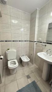 a bathroom with a toilet and a sink at Increible Departamento en Ciudad de Mendoza, a metros de Parque Central y proximo a microcentro con cochera Pellegrini Apartments Parque Central in La Cieneguita