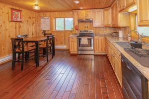 a kitchen with wooden floors and a table and a stove at Golden Oasis in Golden