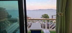 a view of the water from a balcony with a bench at Ganghwado Katana Pension in Incheon