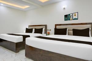 Ένα ή περισσότερα κρεβάτια σε δωμάτιο στο Hotel O Aqua Comforts