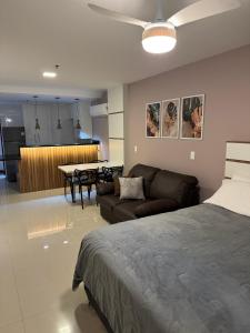 a living room with a couch and a dining room at Loft Com Vista Para O Mar in Arraial do Cabo