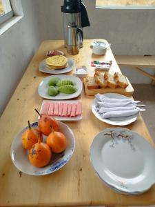 a wooden table with plates of food on it at Bearded Moutaineer sacred garden & lodge in San Salvador