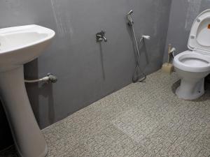 une salle de bain avec un lavabo et des toilettes dans l'établissement Turtle Sea Guest & Restaurants, à Matara