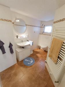 un baño con lavabo y espejo en Bauernstube-Landhaus-Haan, en Norddeich