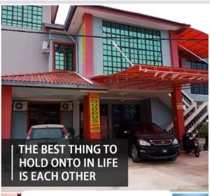 a sign that says the best thing to hold onto in life is each other at Quddus Inn villa in Wakaf Baharu