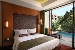 Postel nebo postele na pokoji v ubytování Golden Tulip Jineng Resort Bali