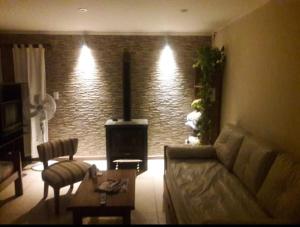 a living room with a couch and a brick wall at My Soul in Camet Norte
