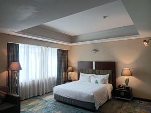 a hotel room with a bed and a large window at Dong Fang Hotel Guangzhou - Free Canton Fair Shuttle Bus & Overseas Buyer Registration Services in Guangzhou +120 photos