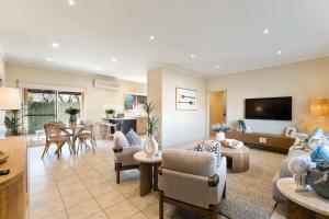 a living room with a couch and a table at Hinkler on the Lane - Stylish Coastal Escape in Victor Harbor