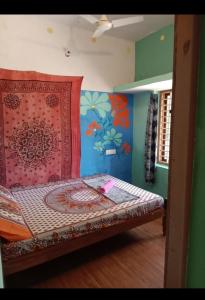 a small bed in a room with a wall at Ever green home stay in Alleppey