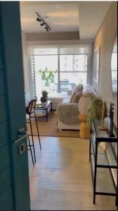 a living room with a couch and a table at Mi Ventana del Mar 3G in Chame