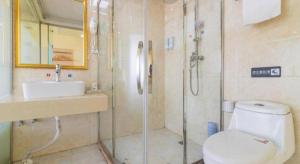 a bathroom with a shower and a toilet and a sink at Pai Hotel Tianjin Binguan Metro Station Municipal Government in Tianjin +132 photos
