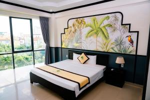 a bedroom with a bed with a painting on the wall at Khách sạn Đại An Ninh Bình in Ninh Binh +124 photos