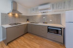 cocina con fregadero y microondas en Seahorse Motel Cowes en Cowes