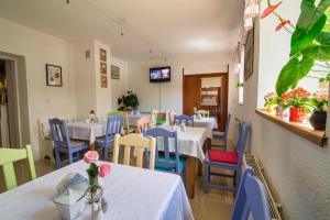 a restaurant with tables and chairs and a tv at Sandomiria in Sandomierz