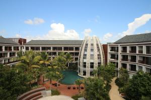 a view of a resort with a pool and a building at Golden Tulip Jineng Resort Bali in Kuta