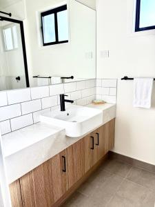 a bathroom with a white sink and a mirror at BIG4 Rutherglen Holiday Park in Rutherglen +68 photos