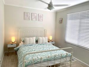 a bedroom with a bed and a ceiling fan at River Retreat in American River