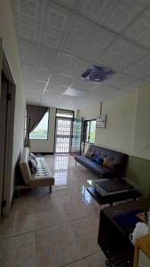 a living room with a couch and a chair at Baruna Homestay in Wutai