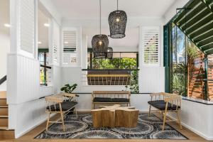 a restaurant with two tables and two chairs and windows at The Leea Resort Darwin in Darwin +16 photos