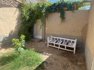 a white bed sitting next to a building at Home of Natural in Luxor