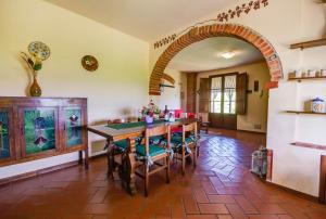 a dining room with an archway and a table and chairs at Agriturismo San Francesco in Cortona