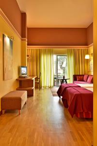 a bedroom with a bed and a desk and a television at Pestana Sintra Golf Resort & SPA Hotel in Sintra