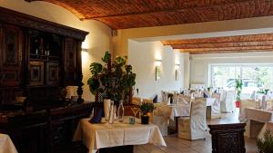 a dining room with white tables and white chairs at Pension Central in Markt Piesting