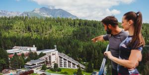 a man and a woman standing on top of a mountain at Hotel FIS in Štrbské Pleso