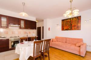 a living room with a table and a couch at Apartment Marela in Mokošica