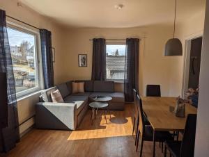 a living room with a couch and a table at Railside Track Apartment OJ1-2 in Narvik