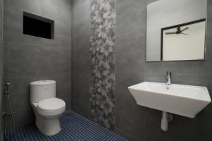 a bathroom with a toilet and a sink at Calangute Beach Home Away in Calangute