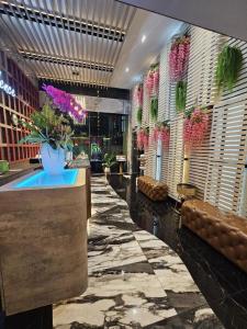 a lobby with a vase of flowers in a building at The Park Residence in Bangkok