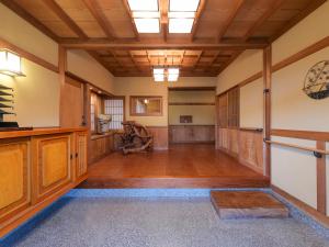 a large room with wooden floors and a wooden ceiling at Kazeno Ryoan Fuga-風乃旅庵 楓雅 in Koshu
