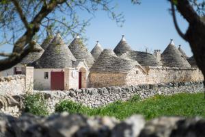 an old stone wall with a building with turrets at Le Dieci Porte in Alberobello