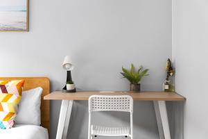 a desk with a chair next to a bed at Budget Double Room in Belmore - Convenient Stay Near Shops - Shared Bathroom in Sydney