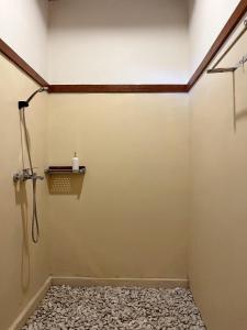 a shower in a bathroom with a wall at Lombok Riverside Bungalows in Masbagik +54 photos