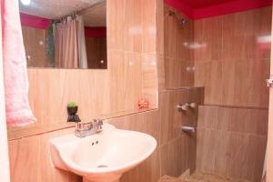 a bathroom with a sink and a mirror at Cindy's Garden Stay in Ocho Rios +30 photos