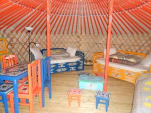 Camping Kerlaudy Mer et Yourtes في Plouénan: غرفة بسريرين وطاولة وكراسي