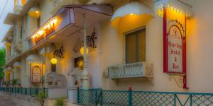 a building with signs on the side of it at Garden Hotel by HRH Group of Hotels in Udaipur