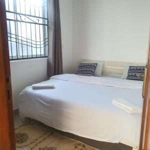 モンバサにあるCosy 1bedroom hideout within Mombasa CBDの窓のある部屋のベッド