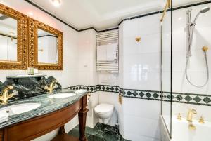 a bathroom with a sink, toilet and bathtub at La Villa Royale in Paris