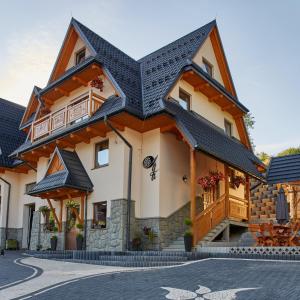 a large house with a black roof at Aga in Suche
