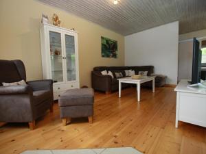 a living room with a couch and a table at Ferienhaus in Clausthal-Zellerfeld mit Terrasse in Clausthal-Zellerfeld