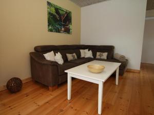 a living room with a couch and a table at Ferienhaus in Clausthal-Zellerfeld mit Terrasse in Clausthal-Zellerfeld